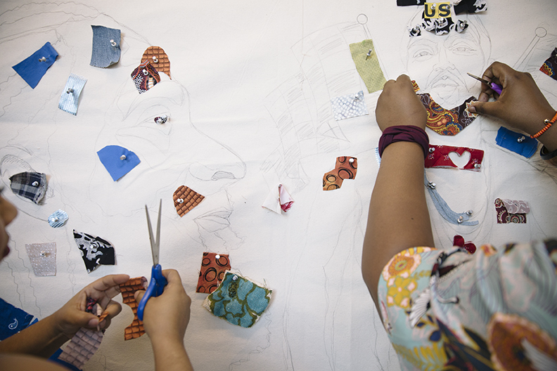 Visitors contribute to the Nipsey Hussle community quilt at Art + Practice. Leimert Park, Los Angeles, CA. 12 October 2019. Photo by Molly Adams.